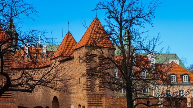 Red brick walls and towers of Warsaw Barbican, Poland in spring