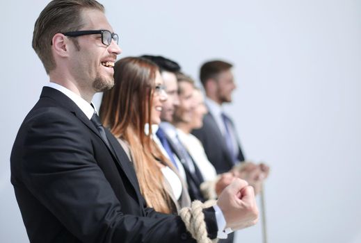 close up.a group of successful business people tied with one rope.photo with copy space
