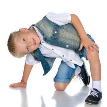Cute little boy squatting on his haunches on the playground.Isolated on white background.
