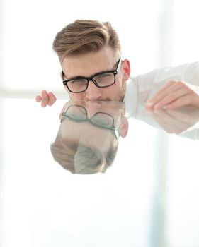 close up.businessman looking from behind the glass table.photo with copy space