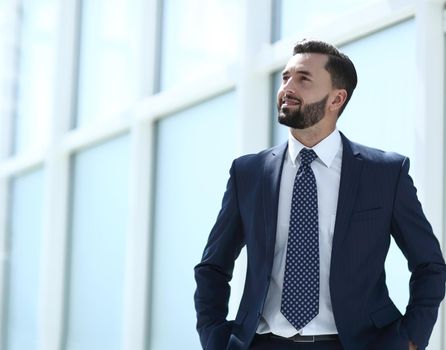 dreaming businessman standing in a bright office.photo with copy space