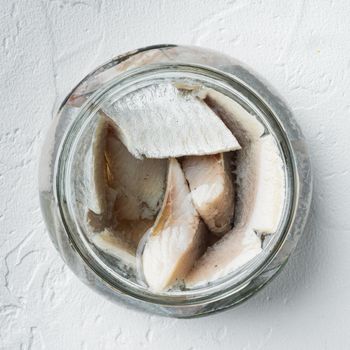 Canned Herring , fish preserves set, in glass jar, on white background, top view flat lay, square format
