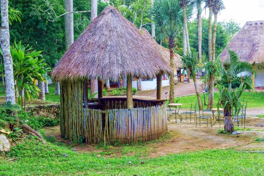 Romantic gazebo in the park with thatched roof. The concept of a family holiday, tourism.