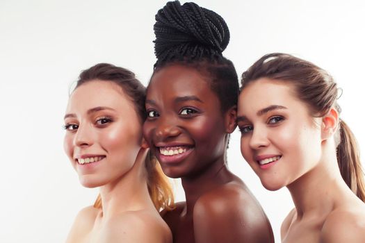 three different nation woman: african-american, caucasian together isolated on white background happy smiling, diverse type on skin, lifestyle real people concept close up