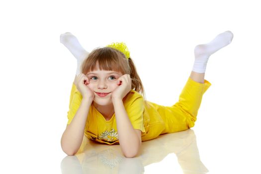 Girl with a short bangs on her head and bright yellow overalls.She crouched down on the white advertising banner.