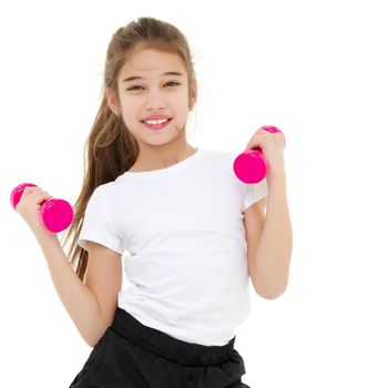 A cute little girl doing exercises with dumbbells. The concept of strength, health and sport. Isolated on white background.