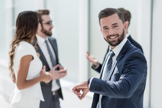 confident businessman looking at his wristwatch.business concept