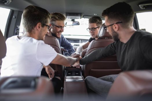 Conversation of four business colleagues in a moving car