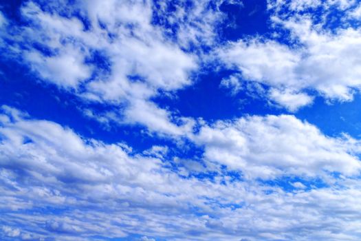 Thick cumulus clouds against a blue sky.