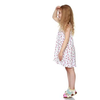 Little girl pointing at something. The concept of advertising children's products. Isolated on white background.