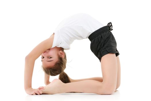 A little girl gymnast performs a bridge. The concept of childhood, sport, healthy lifestyle. Isolated on white background.