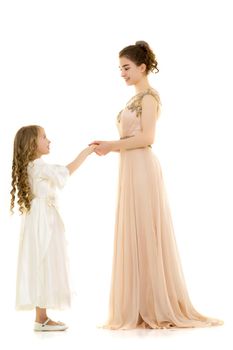 Beautiful young girl hugging her little sister. The concept of a happy childhood, family values. Isolated on white background.