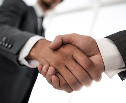 Close up view of business partnership handshake concept.Photo of two businessman handshaking process.Successful deal after great meeting.