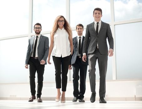 in full growth.a group of business people passing through the hall of the office.photo with copy space