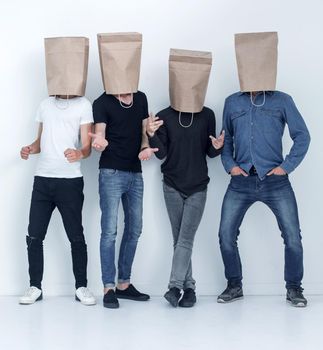 in full growth. a group of young people with paper bags on their heads.photo with copy space
