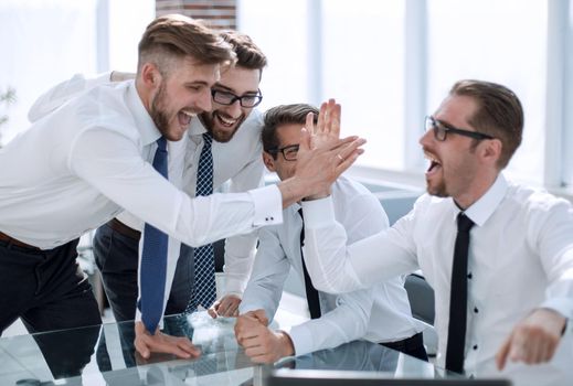 employees giving each other a high five.success concept