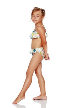 Tanned little girl in a swimsuit. The concept of summer family vacations in the sea. Happy childhood. Isolated on white background.