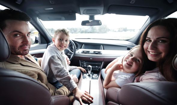 close up.smiling family sitting in a comfortable car. family holiday