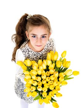 A cute little girl with a bouquet of tulips, in the spring in the studio. The concept of the awakening of nature after winter, the expectation of summer.Isolated on white background.
