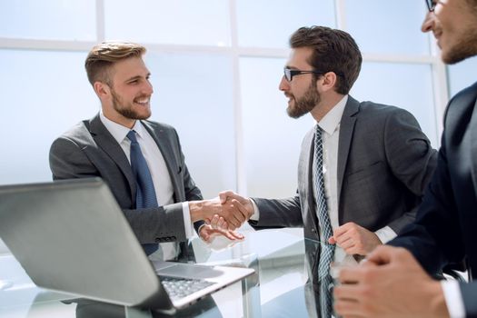 handshake employees at the Desk.the concept of cooperation