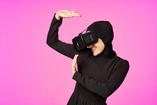 woman in black hijab glasses virtual reality technology movie watching. High quality photo