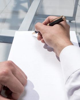 rear view. businessman signing contract.photo with copy space