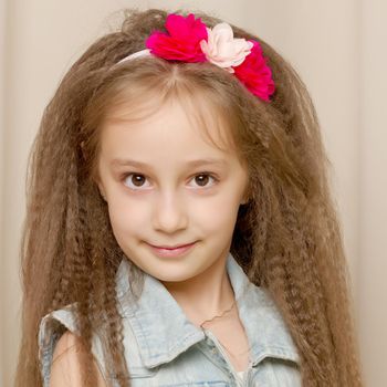 Beautiful little girl close-up. The concept of beauty and fashion, happy childhood. Isolated on white background.