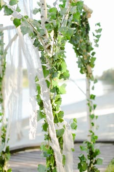 Birch arch in sky background. Concept of natural decorations.