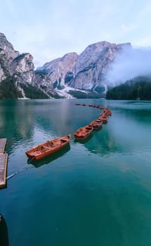 Beautiful landscape of Braies Lake Lago di Braies, romantic place with wooden bridge and boats on the alpine lake, Alps Mountains, Dolomites, Italy, Europe