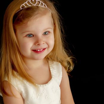 Beautiful little girl on a black background. Studio photography