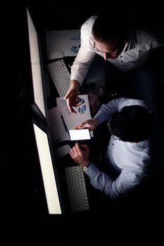 top view .business colleagues using gadgets to work with financial data.business and technology