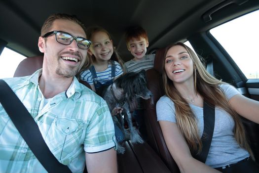 close up. happy family in a comfortable car.family holiday concept