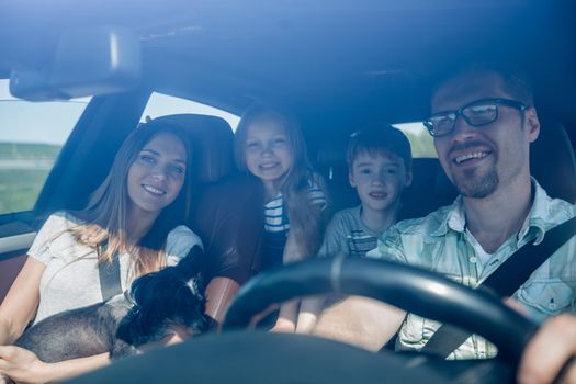 family with two children traveling in a family car.family holiday concept