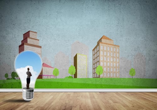 Businesswoman inside light bulb against city drawn concept