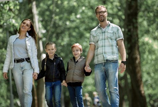family with two children on a walk in the Park. lifestyle