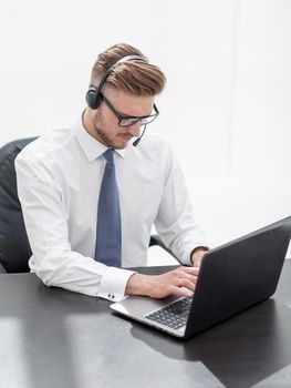 business center employee working on a laptop .photo with copy space