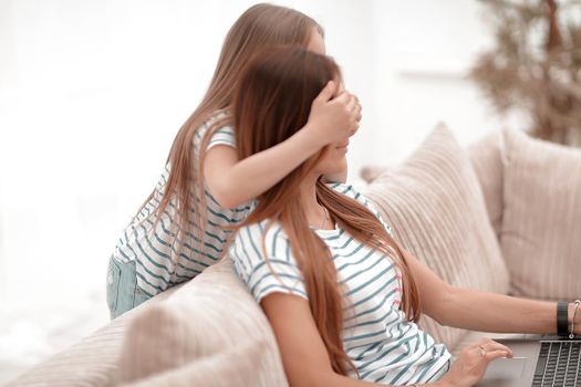 guess who. a little girl playing with her mother . the concept of family happiness