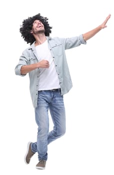 in full growth. stylish young man pointing to copy space .isolated on white background