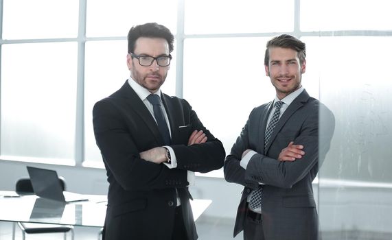 two confident business partners standing in the office. photo with copy space