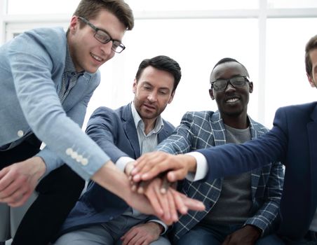 business team is putting their hands together.the concept of unity