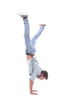 in full growth. happy young man standing on his hands. isolated on white background
