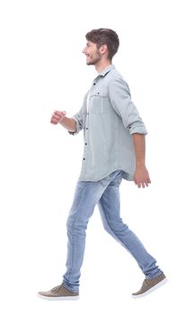 side view. a smiling young man steps forward.isolated on white background