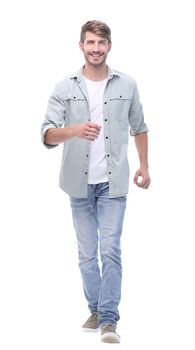 in full growth. a successful young man confidently steps forward.isolated on white background