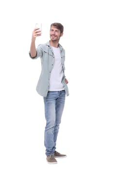 in full growth.young man taking selfie.isolated on white background.