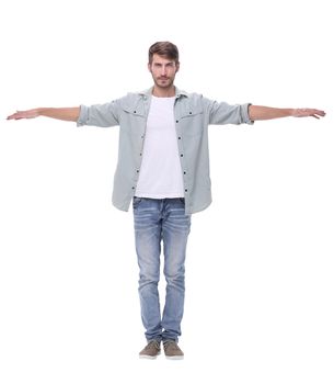 in full growth.young man spreading his hands apart.isolated on white background