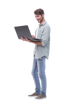 in full growth.smiling young man with laptop .isolated on white background