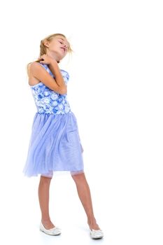 Portrait of a positive and stylish little girl in a summer dress, rejoices in the wind that blows and moves her dress and hair. The concept of beauty and fashion. Isolated on white background.