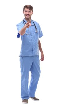 in full growth.a medical doctor with a stethoscope pointing at you.isolated on white background