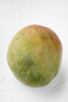 Whole ripe mango set, on white stone table background