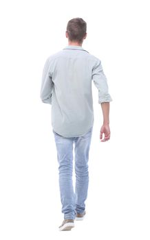 rear view. young man in jeans looking at copy space.isolated on white background